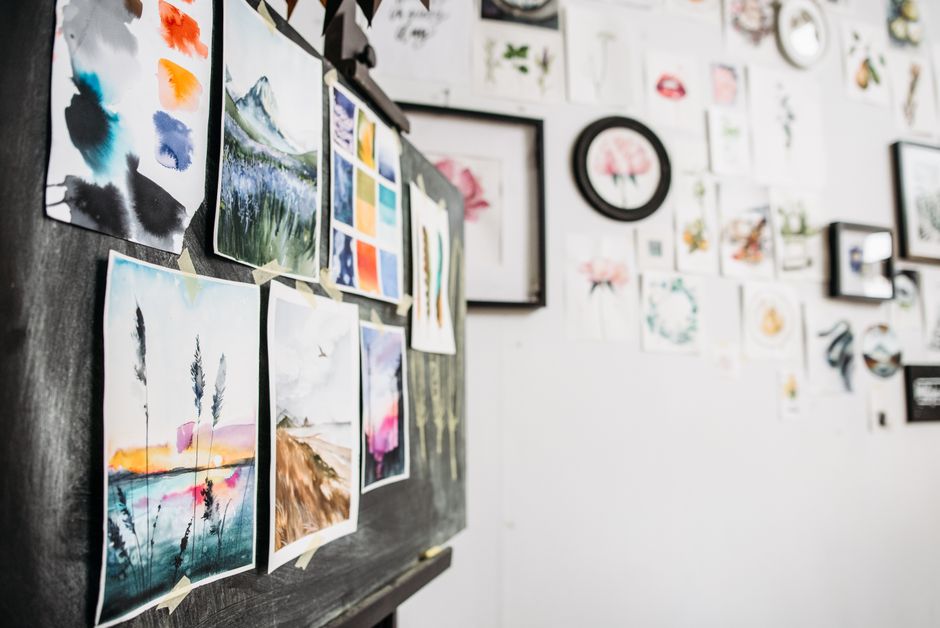Art studio interior showcasing watercolor paintings on a board, displaying creativity and design.